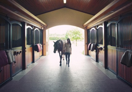 Geargina Bloomberg entering her stables after a day of competing at the Winter Equestrian Festival